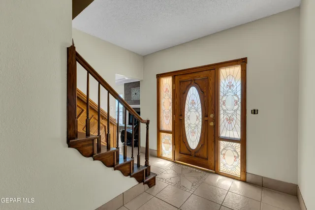 a dining room with furniture a chandelier and a window