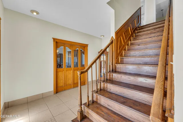 a view of a dining room with furniture and a chandelier