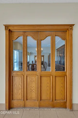 a dining room with furniture a chandelier and wooden floor