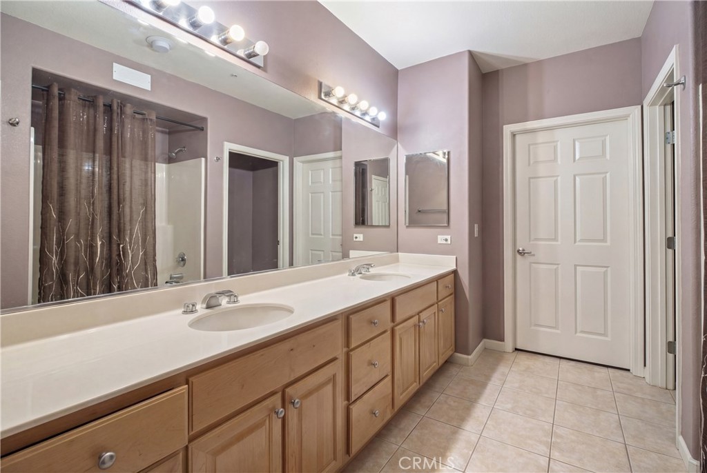 1390 Saddle Rack Street, Unit 308 San Jose, CA 95126 - Photo 16 of 32 a bathroom with a double vanity sink and a mirror
