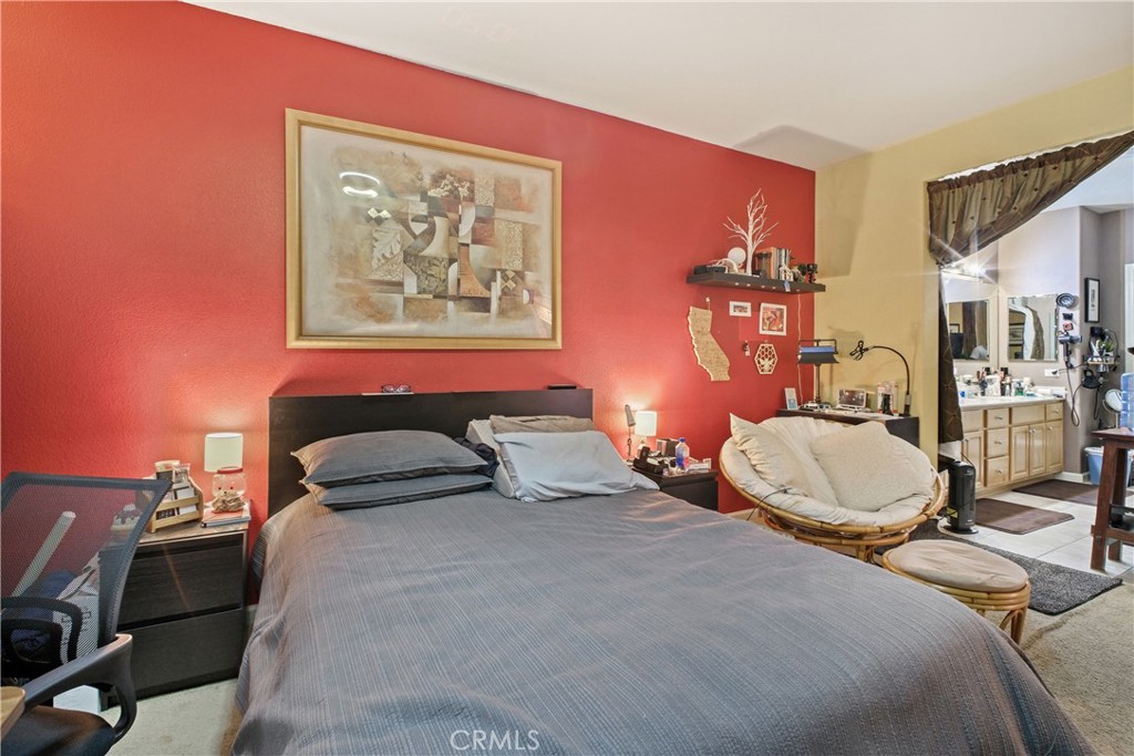 1390 Saddle Rack Street, Unit 308 San Jose, CA 95126 - Photo 18 of 32 a bedroom with a bed and a lamp with the bookshelf