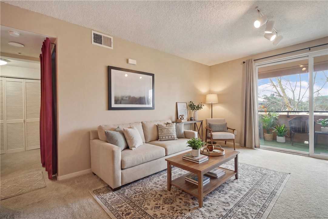 1390 Saddle Rack Street, Unit 308 San Jose, CA 95126 - Photo 22 of 32 a living room with furniture and a large window