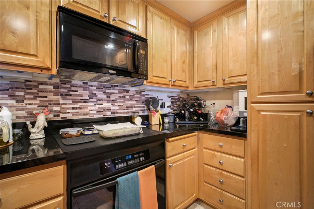 1390 Saddle Rack Street, Unit 308 San Jose, CA 95126 - Photo 8 of 32 a kitchen with stainless steel appliances granite countertop a stove and a microwave