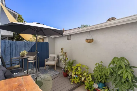 a backyard of a house with table and chairs