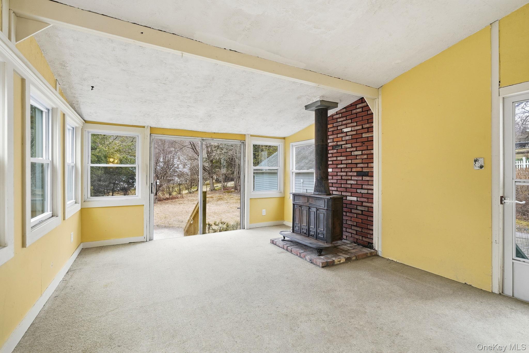 33 Mountain Road Irvington, NY 10533 - Photo 18 of 38 Unheated bonus room from kitchen leading out to the level back yard.
