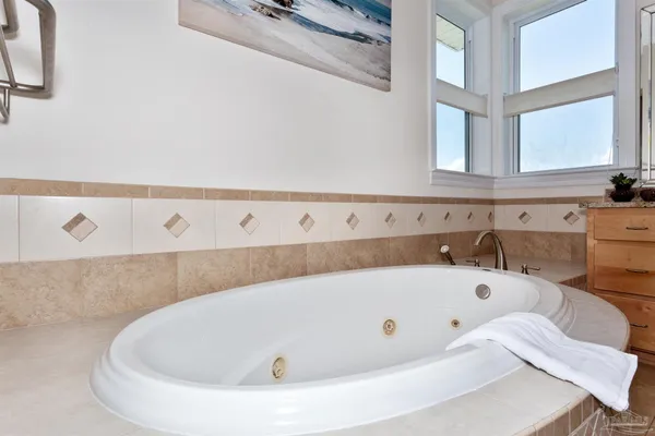 a bathroom with a bathtub and a window