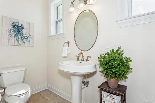a bathroom with a sink toilet and a mirror