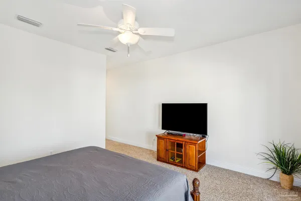 a living room with a flat screen tv and white walls