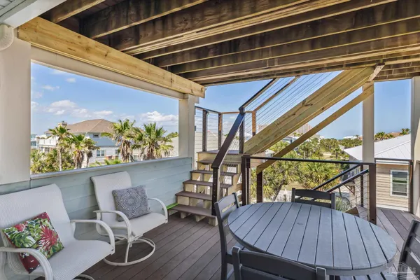a view of a porch with furniture and wooden floor
