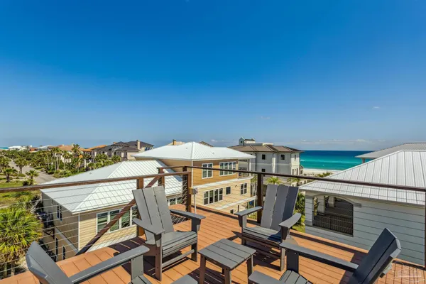 a view of a roof deck with table and chairs
