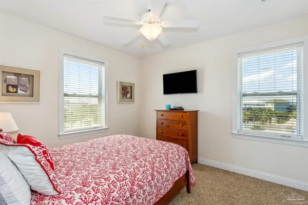a bedroom with a large bed and a chandelier