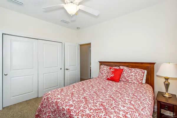 a bedroom with furniture and a flat screen tv