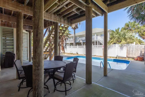 a swimming pool with outdoor seating