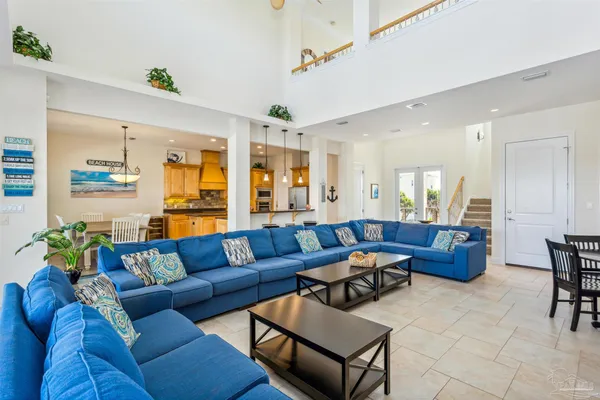 a living room with furniture and wooden floors