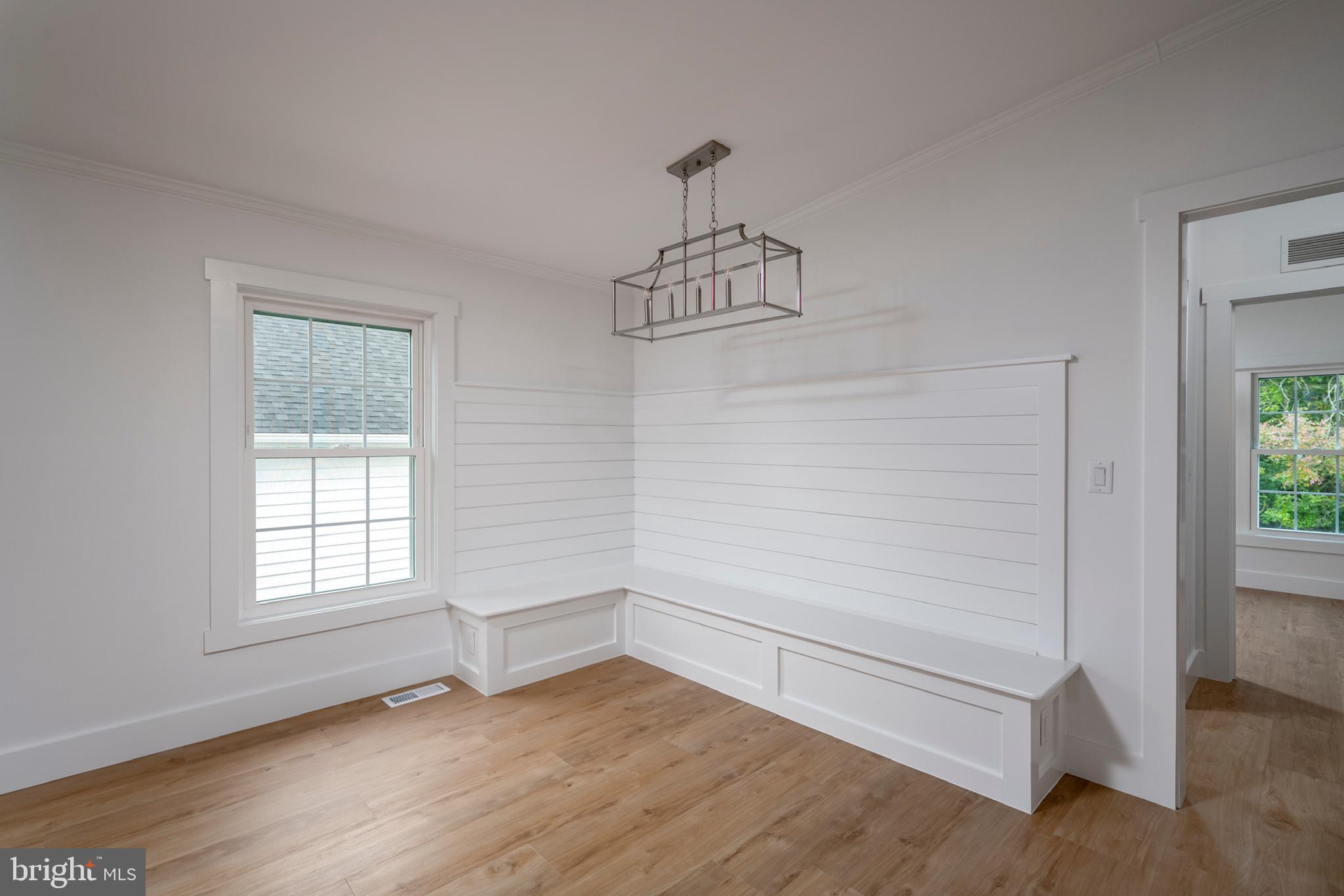 12403 Salisbury Road Ocean City, MD 21842 - Photo 12 of 28 a view of empty room with wooden floor and fan