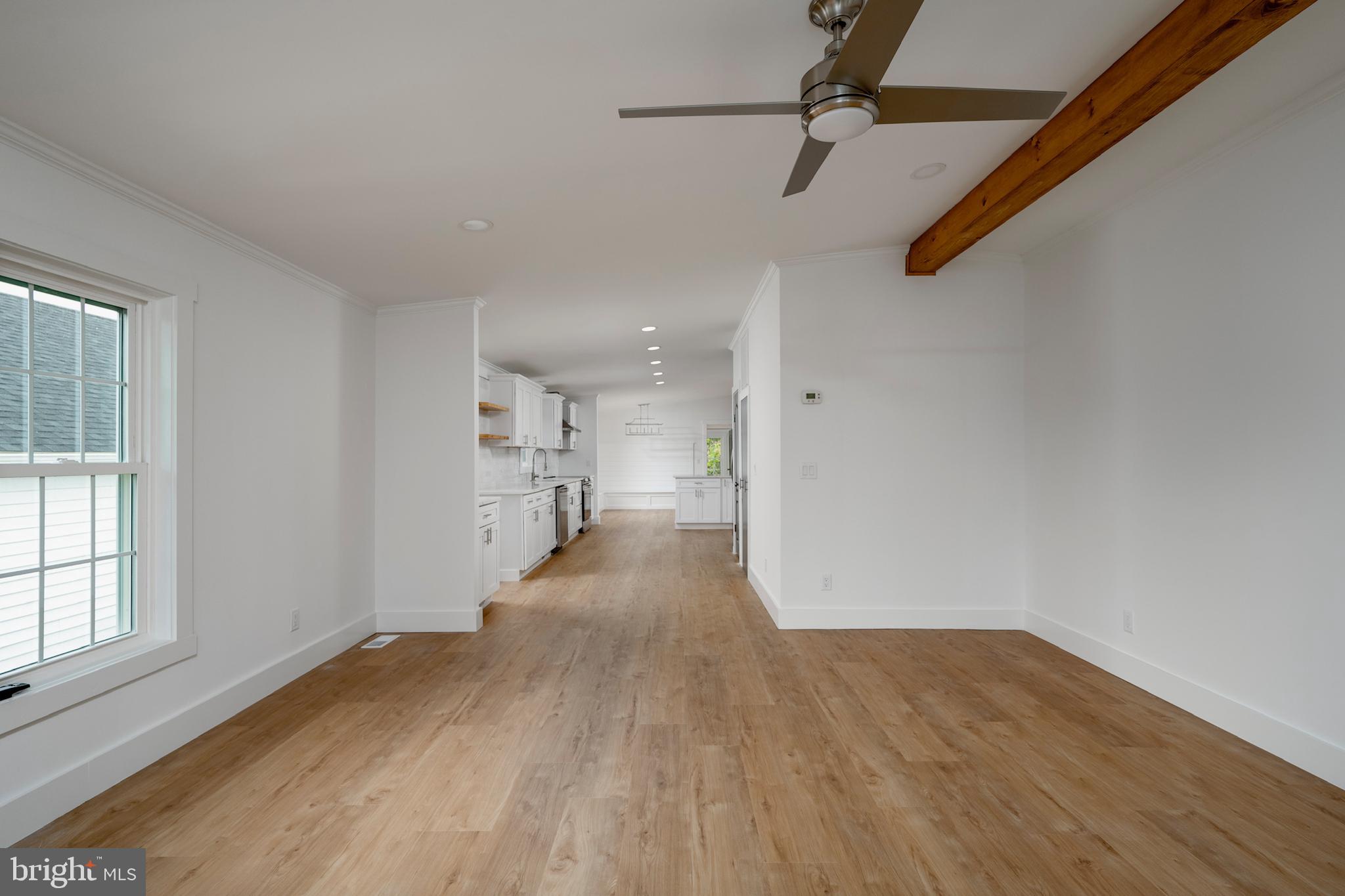 12403 Salisbury Road Ocean City, MD 21842 - Photo 18 of 28 wooden floor in an empty room with a window
