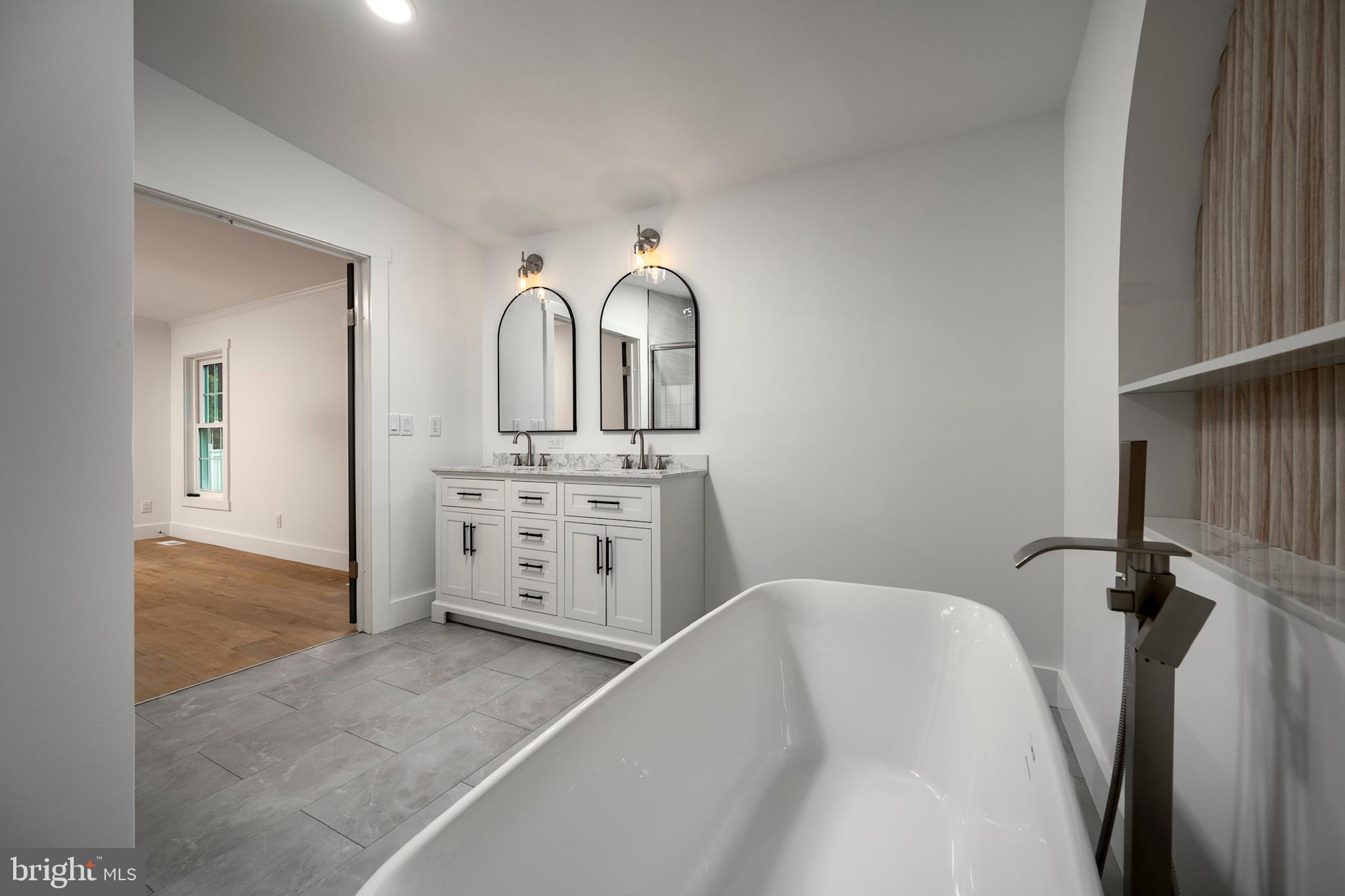 12403 Salisbury Road Ocean City, MD 21842 - Photo 24 of 28 a view of a bathroom with mirror and bathtub