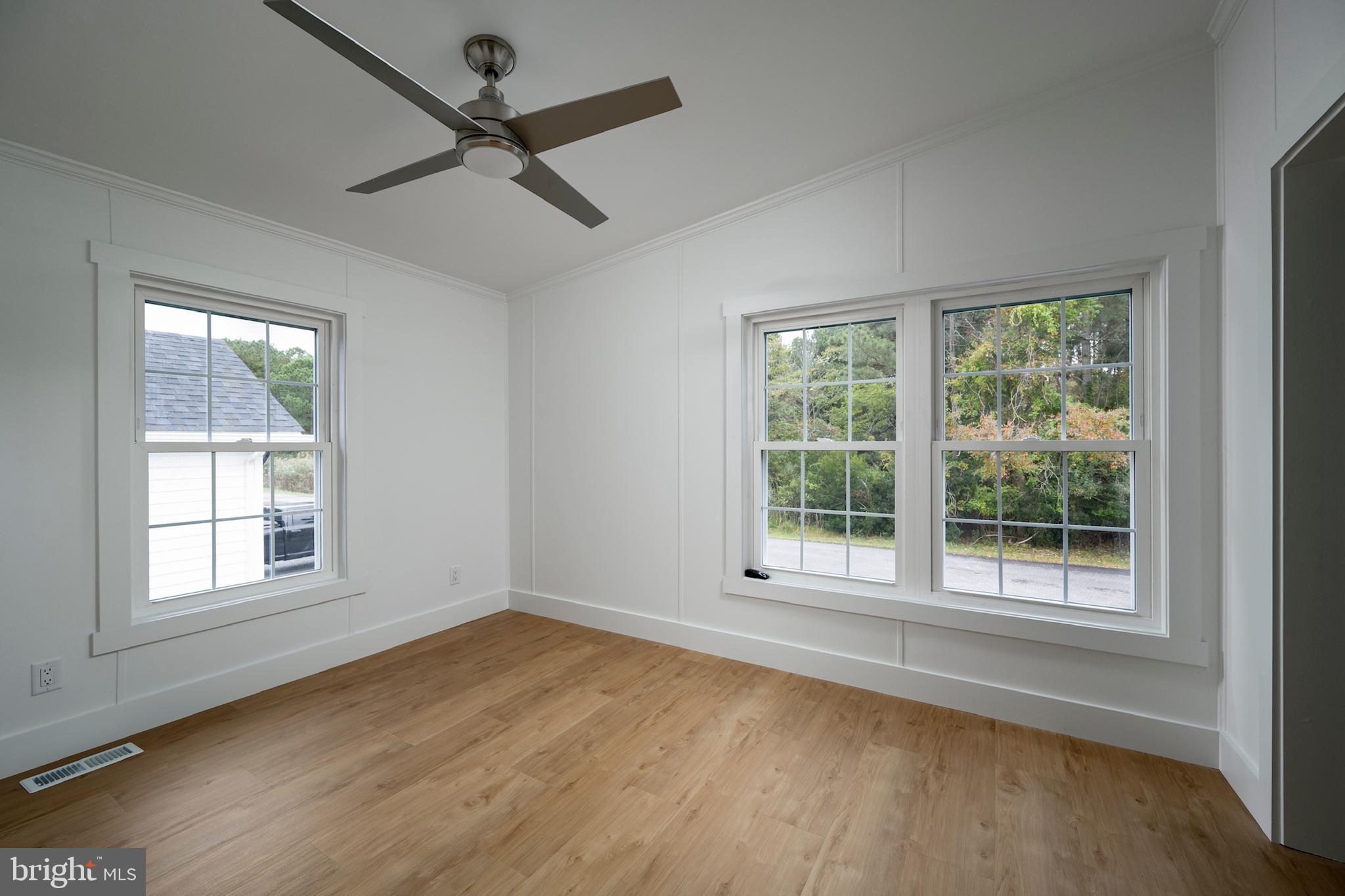 12403 Salisbury Road Ocean City, MD 21842 - Photo 27 of 28 a view of an empty room with a window and wooden floor