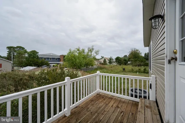 a balcony with wooden floor and fence