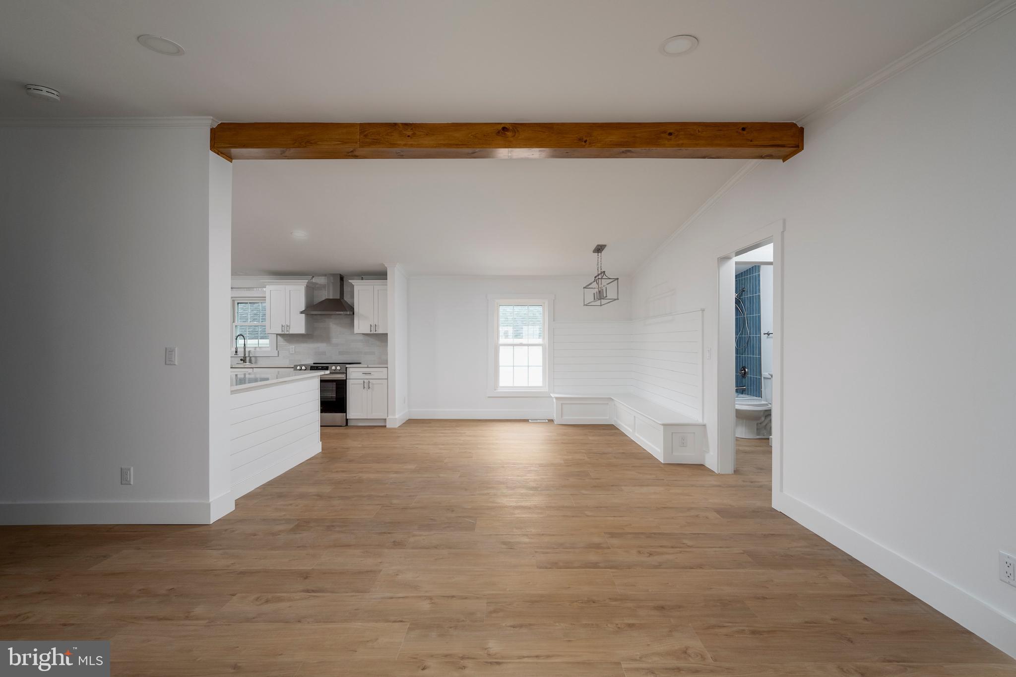 12403 Salisbury Road Ocean City, MD 21842 - Photo 10 of 28 a view of empty room with wooden floor and cabinet