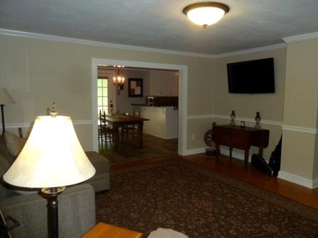 1709 6 Mile Post Road Callaway, VA 24067 - Photo 6 of 36 a living room with a table chairs and a flat screen tv