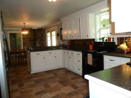 1709 6 Mile Post Road Callaway, VA 24067 - Photo 8 of 36 a kitchen with granite countertop a sink a stove and cabinets