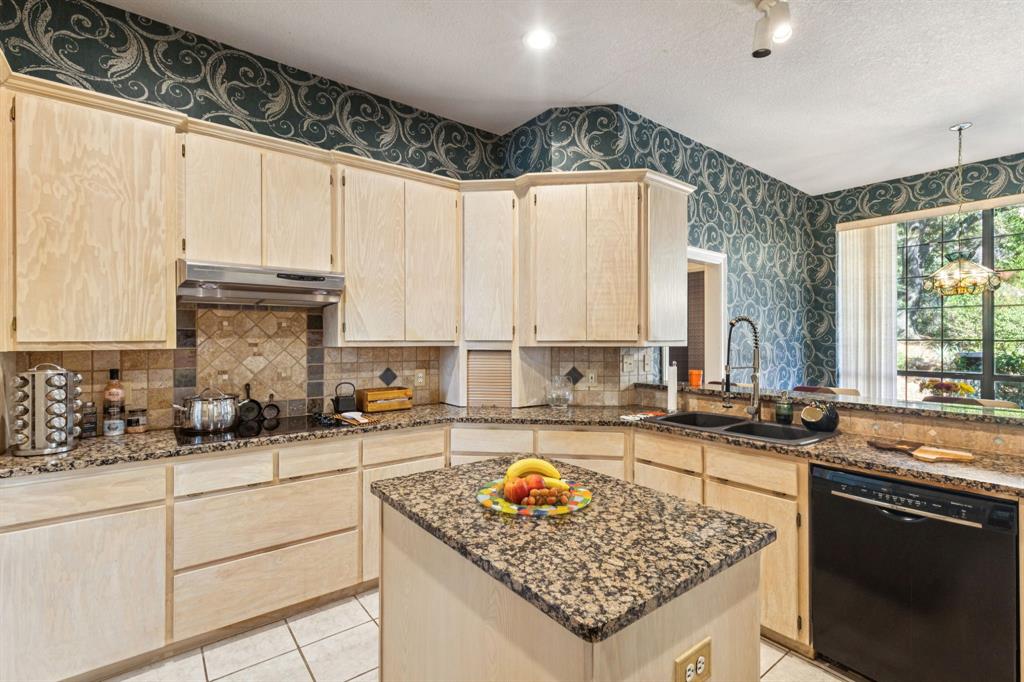 3825 Montecito Drive Denton, TX 76205 - Photo 11 of 37 a kitchen with stainless steel appliances granite countertop a sink stove and cabinets