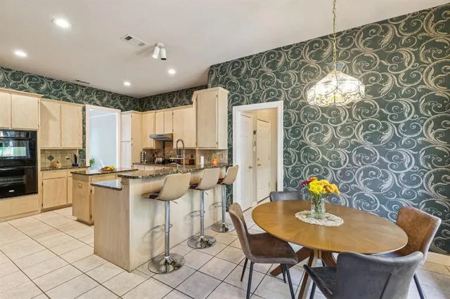 a kitchen with stainless steel appliances kitchen island granite countertop a sink and cabinets
