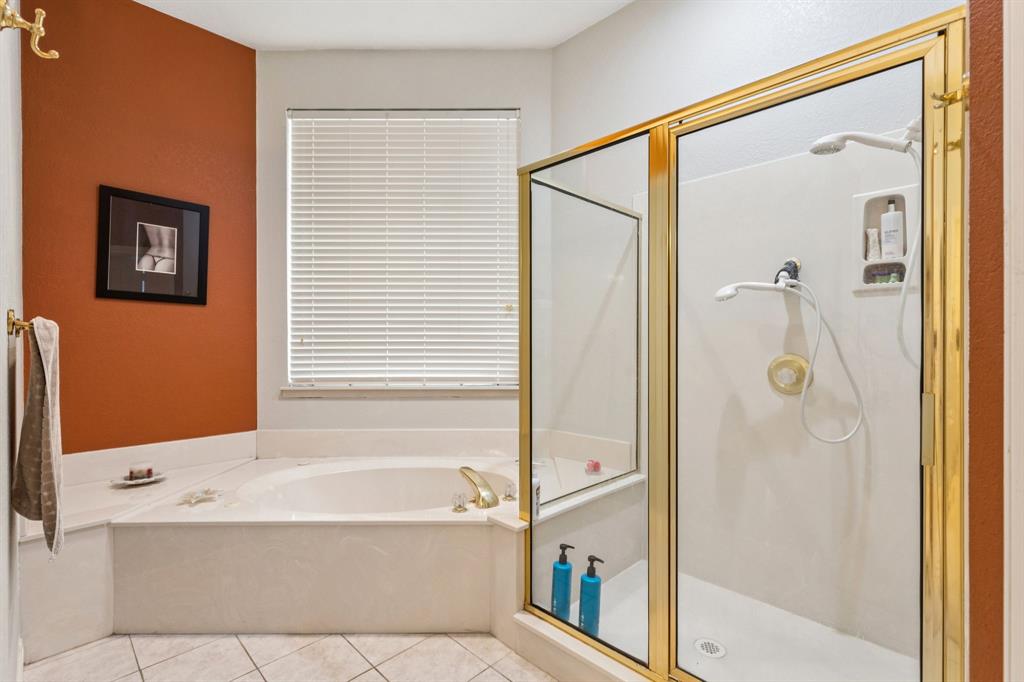 3825 Montecito Drive Denton, TX 76205 - Photo 22 of 37 a bathroom with a bathtub and a shower