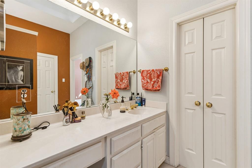 3825 Montecito Drive Denton, TX 76205 - Photo 23 of 37 a bathroom with a sink and a mirror
