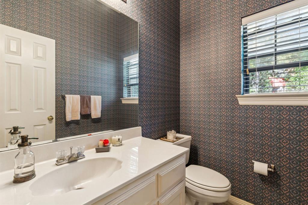 3825 Montecito Drive Denton, TX 76205 - Photo 24 of 37 a bathroom with a sink a toilet and mirror