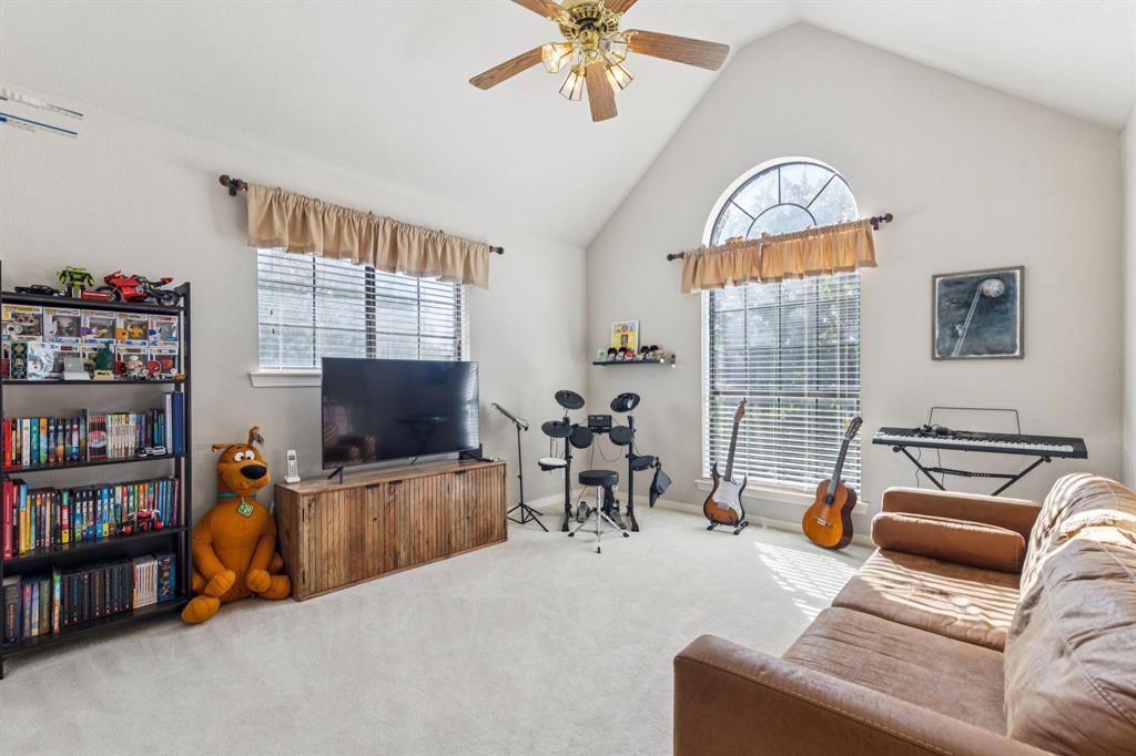 3825 Montecito Drive Denton, TX 76205 - Photo 25 of 37 a living room with furniture a flat screen tv and a window