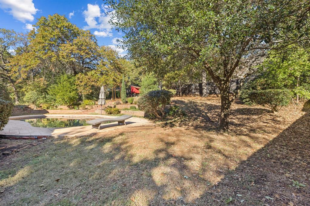 3825 Montecito Drive Denton, TX 76205 - Photo 3 of 37 a view of dirt yard with large trees