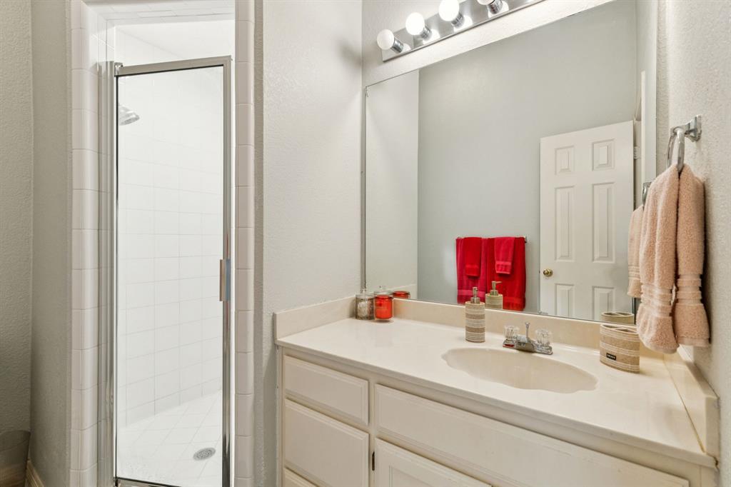 3825 Montecito Drive Denton, TX 76205 - Photo 31 of 37 a bathroom with a sink and a mirror