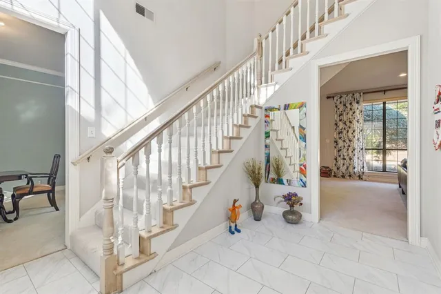 a view of staircase with white walls and windows