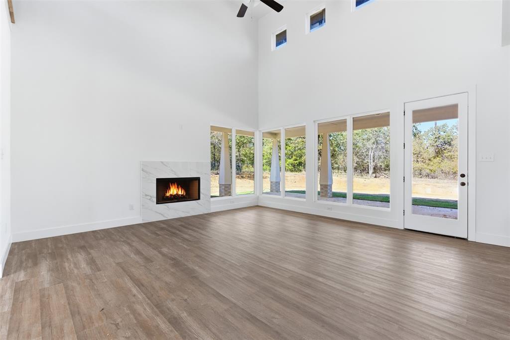 1552 Lakeridge Boulevard Sunset, TX 76270 - Photo 12 of 33 an empty room with wooden floor and windows