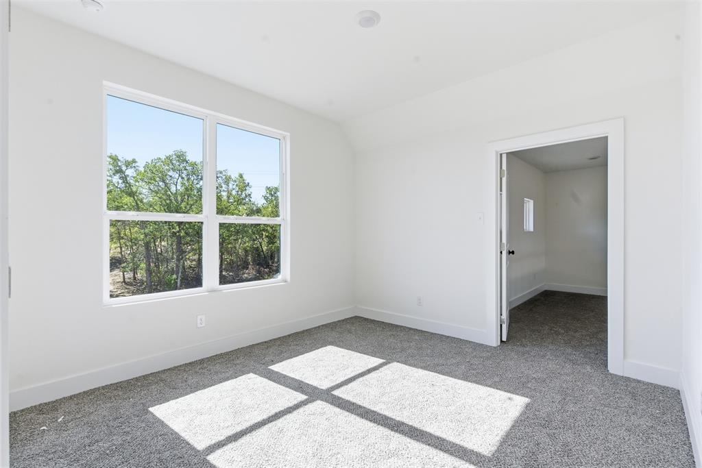 1552 Lakeridge Boulevard Sunset, TX 76270 - Photo 26 of 33 an empty room with a window