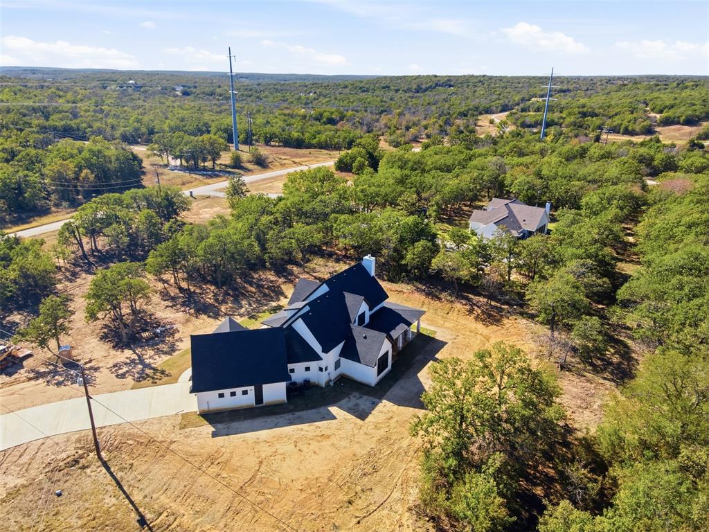 1552 Lakeridge Boulevard Sunset, TX 76270 - Photo 5 of 33 an aerial view of a house with a yard and lake view