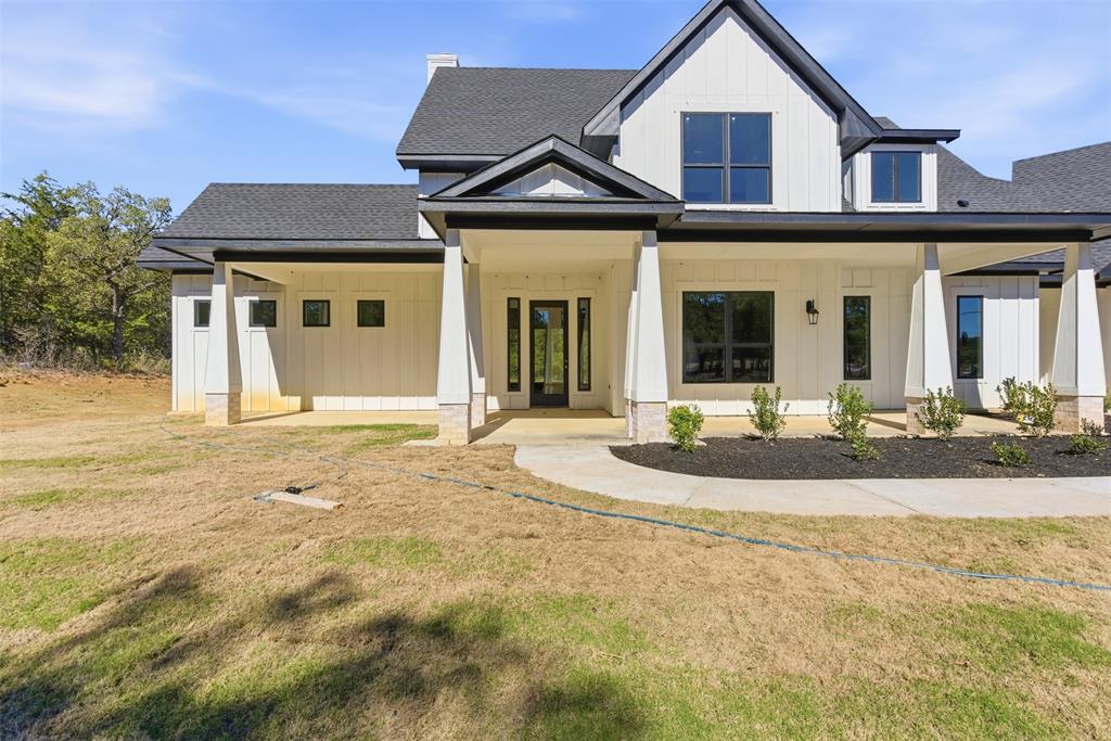 1552 Lakeridge Boulevard Sunset, TX 76270 - Photo 9 of 33 a front view of a house with garden