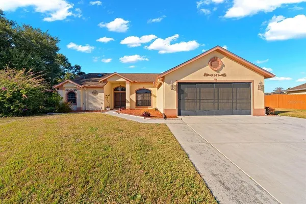a front view of a house with a yard and garage