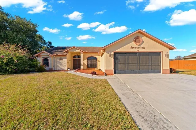 a front view of a house with a yard and garage