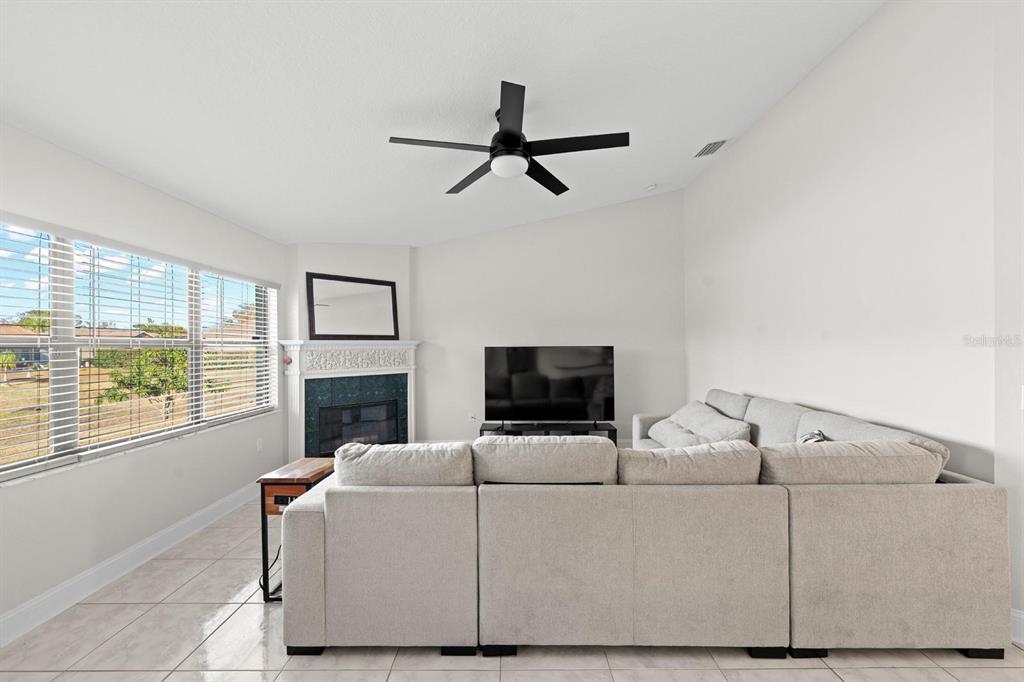 9147 Duffer Court Hudson, FL 34667 - Photo 12 of 15 a living room with furniture and a flat screen tv