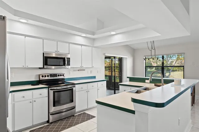 a kitchen with stainless steel appliances white cabinets and sink