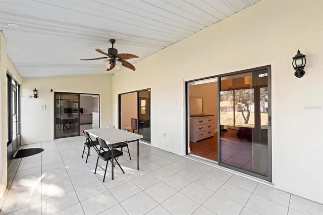a view of a livingroom with furniture and chandelier fan