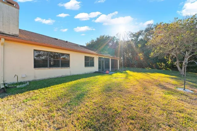 a view of a house with swimming pool and yard
