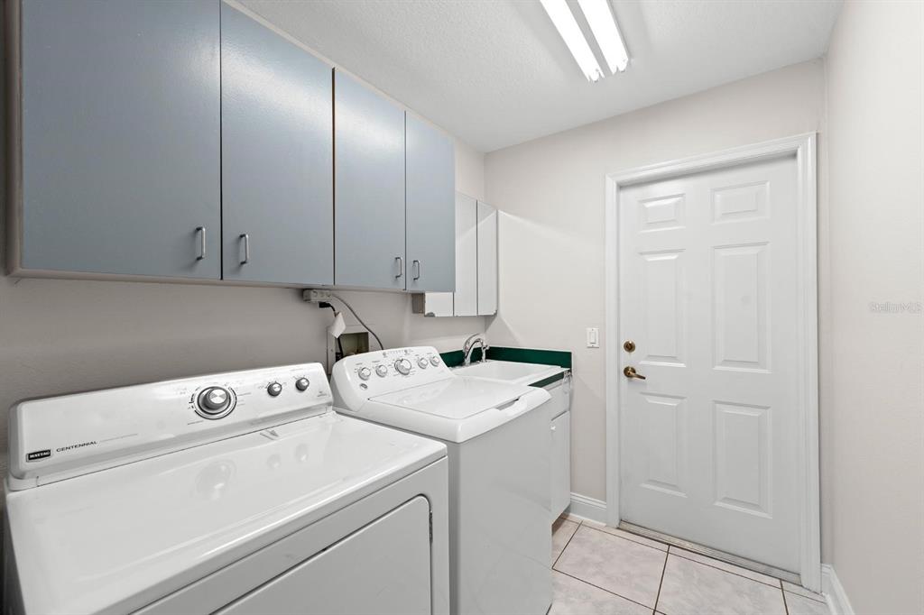 9147 Duffer Court Hudson, FL 34667 - Photo 3 of 15 a view of storage and utility room with washer and dryer