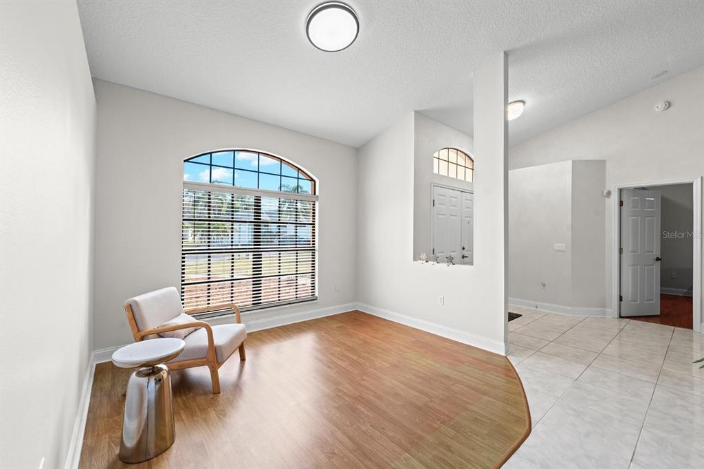 9147 Duffer Court Hudson, FL 34667 - Photo 4 of 15 a view of an empty room with window and wooden floor