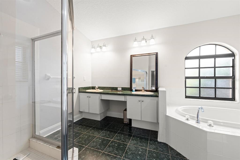 9147 Duffer Court Hudson, FL 34667 - Photo 7 of 15 a bathroom with a bathtub sink and mirror