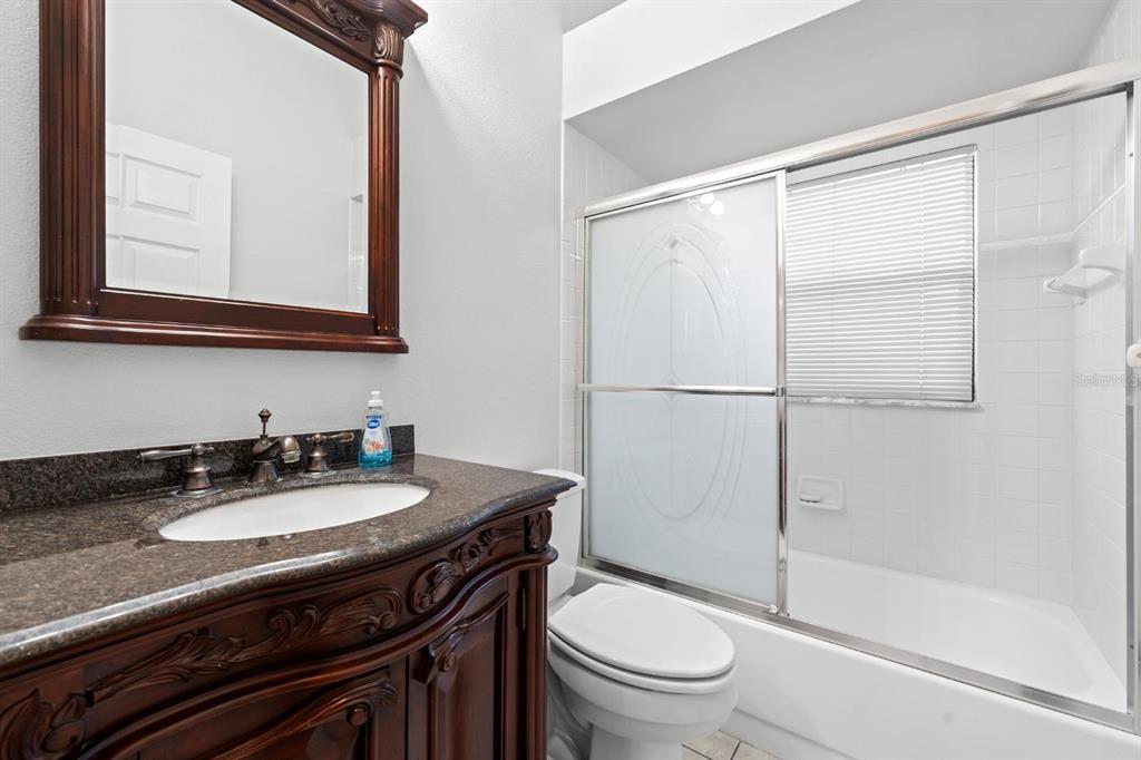 9147 Duffer Court Hudson, FL 34667 - Photo 9 of 15 a bathroom with a sink a toilet a mirror and shower