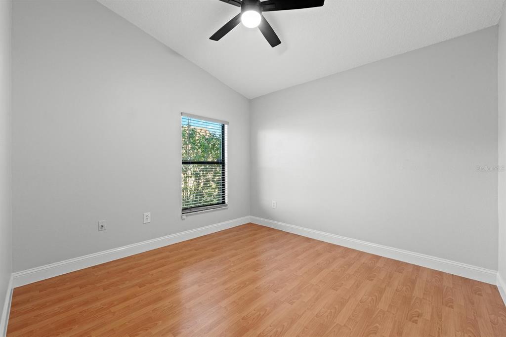 9147 Duffer Court Hudson, FL 34667 - Photo 10 of 15 an empty room with a window and ceiling fan